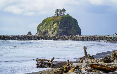 Rocks on beach against sky