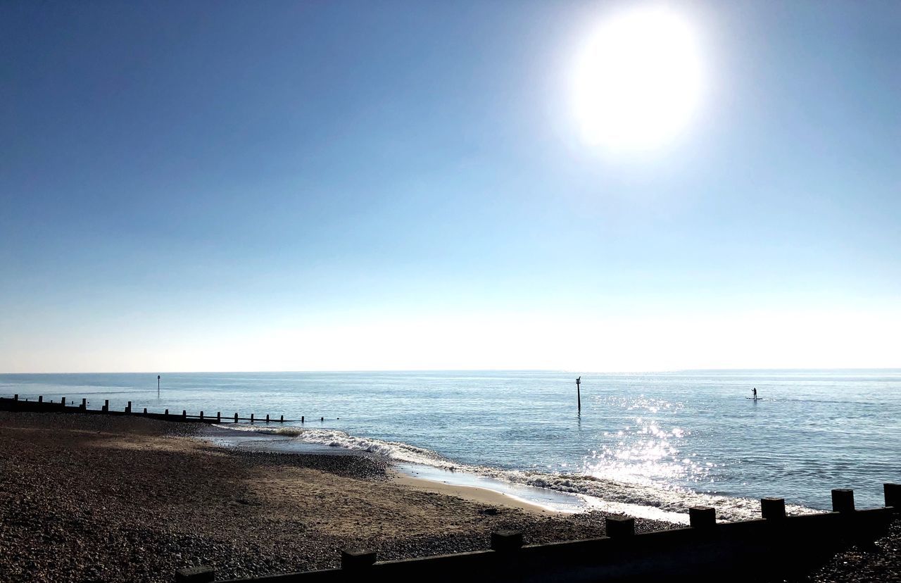 SCENIC VIEW OF SEA AGAINST BRIGHT SUN