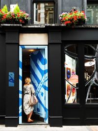 Full length of boy on flower at store