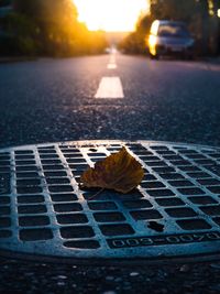 Close-up of sunlight falling on street during sunset