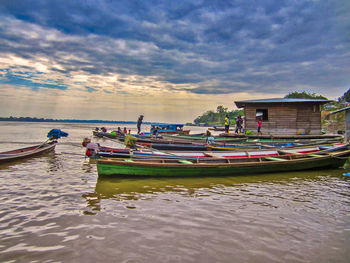 Boats moored in sea against sky