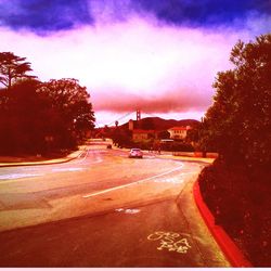 Road against cloudy sky at sunset