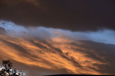 Low angle view of cloudy sky at sunset