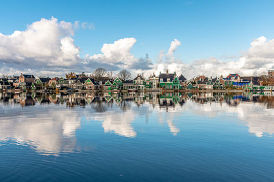 Panoramic view of lake and buildings against sky