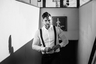 Portrait of handsome man standing on stairs