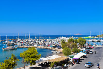 High angle view of boats moored in sea against clear blue sky