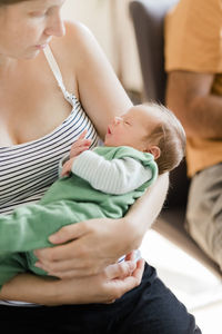 Mother holding baby boy at home