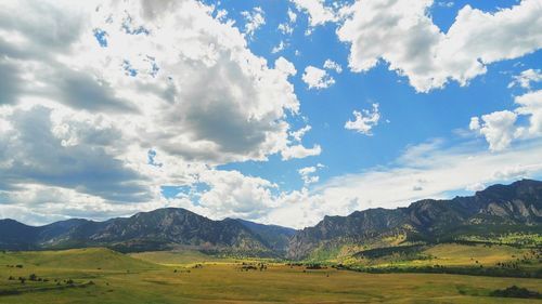 Scenic view of mountains against cloudy sky