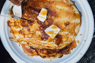 Pancakes flapjacks on plate with butter and syrup and fork