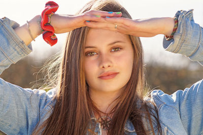 Portrait of beautiful woman shielding eyes 