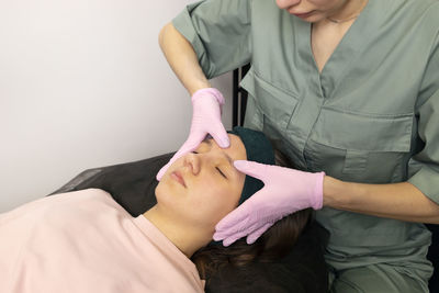 Midsection of doctor examining patient at home