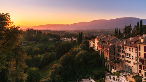 Scenic view of asolo ancient buildings and countryside at sunset, mountains on the background