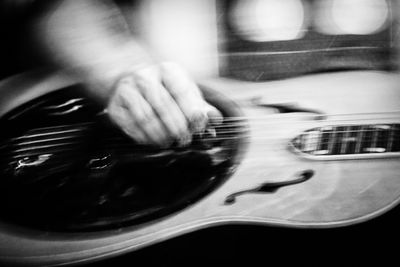 Close-up of man playing guitar