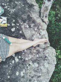 Low section of woman on rock