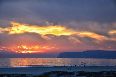 Scenic view of beach against sky during sunset