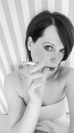 Portrait of beautiful woman smoking cigarette