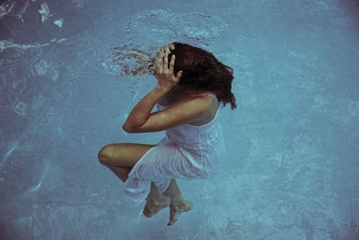 Side view of woman swimming in pool