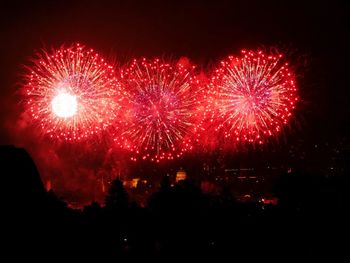 Low angle view of firework display at night