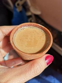 Close-up of hand holding coffee cup