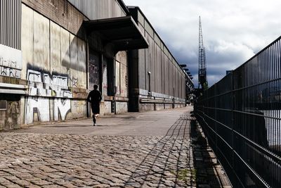 Full length of woman walking on footbridge