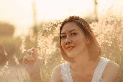 Portrait of woman sitting by plants 