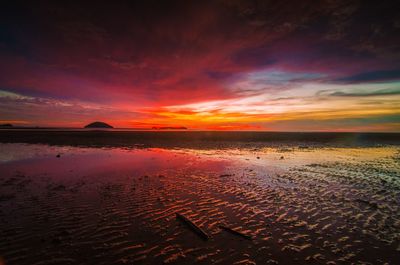 Scenic view of sea against romantic sky at sunset