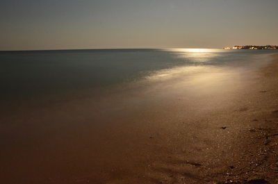 Scenic view of sea against clear sky at sunset