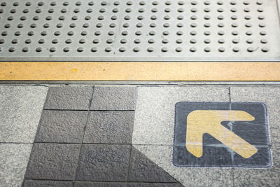 High angle view of sign on footpath