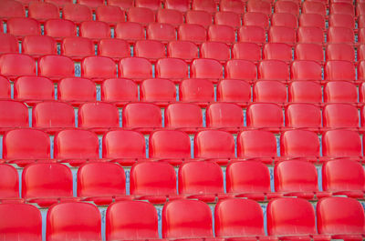 Detail shot of empty red seats in rows