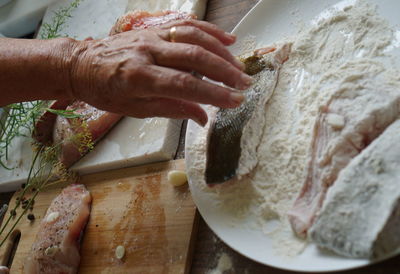 Midsection of woman preparing food at home