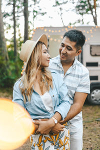 Married asian couple in love travel by camper car on a road trip in nature on their honeymoon