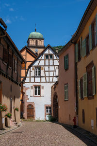 Street amidst buildings against sky in city