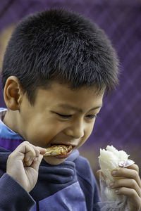 Close-up of boy eating food