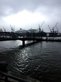 View of harbor against cloudy sky