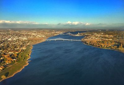 Aerial view of city against cloudy sky