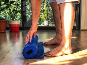 Low section of man working on floor at home