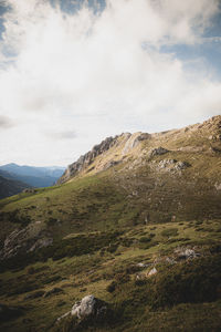 Scenic view of mountains against cloudy sky