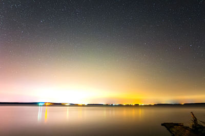 Scenic view of lake against sky at night