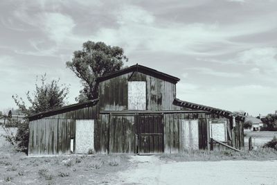 View of house against cloudy sky