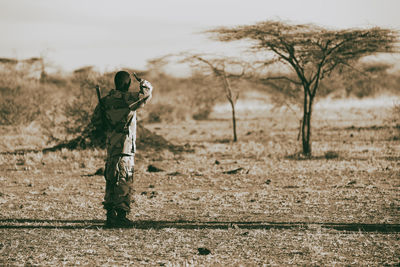 Rear view of boy standing on field