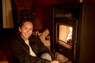 Portrait of cute girl sitting on fire