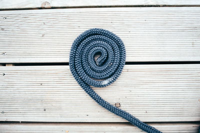 Directly above shot of spiral rope on floorboard