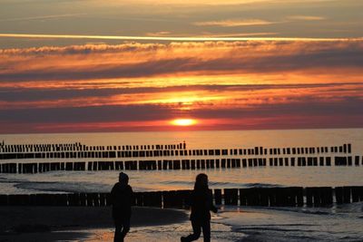 Pier on sea at sunset