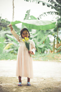 Portrait of a smiling young woman standing outdoors