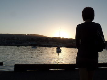 View of people in sea at sunset