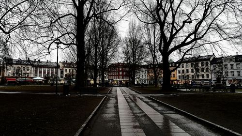 Empty road along buildings