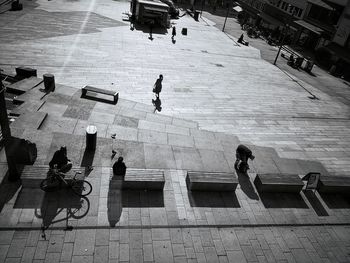 High angle view of people walking on floor in city