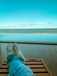 Low section of man relaxing in swimming pool