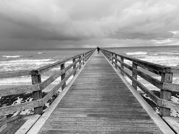 Pier over sea against sky