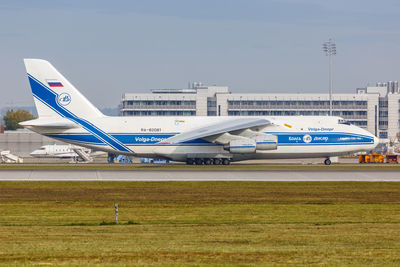 Airplane on airport runway against sky